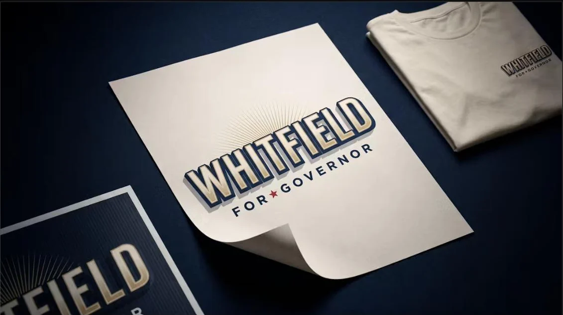 A dimensional campaign logo designed in Ballot Page Brand Studio, shown on a textured poster, shirt, and yard sign